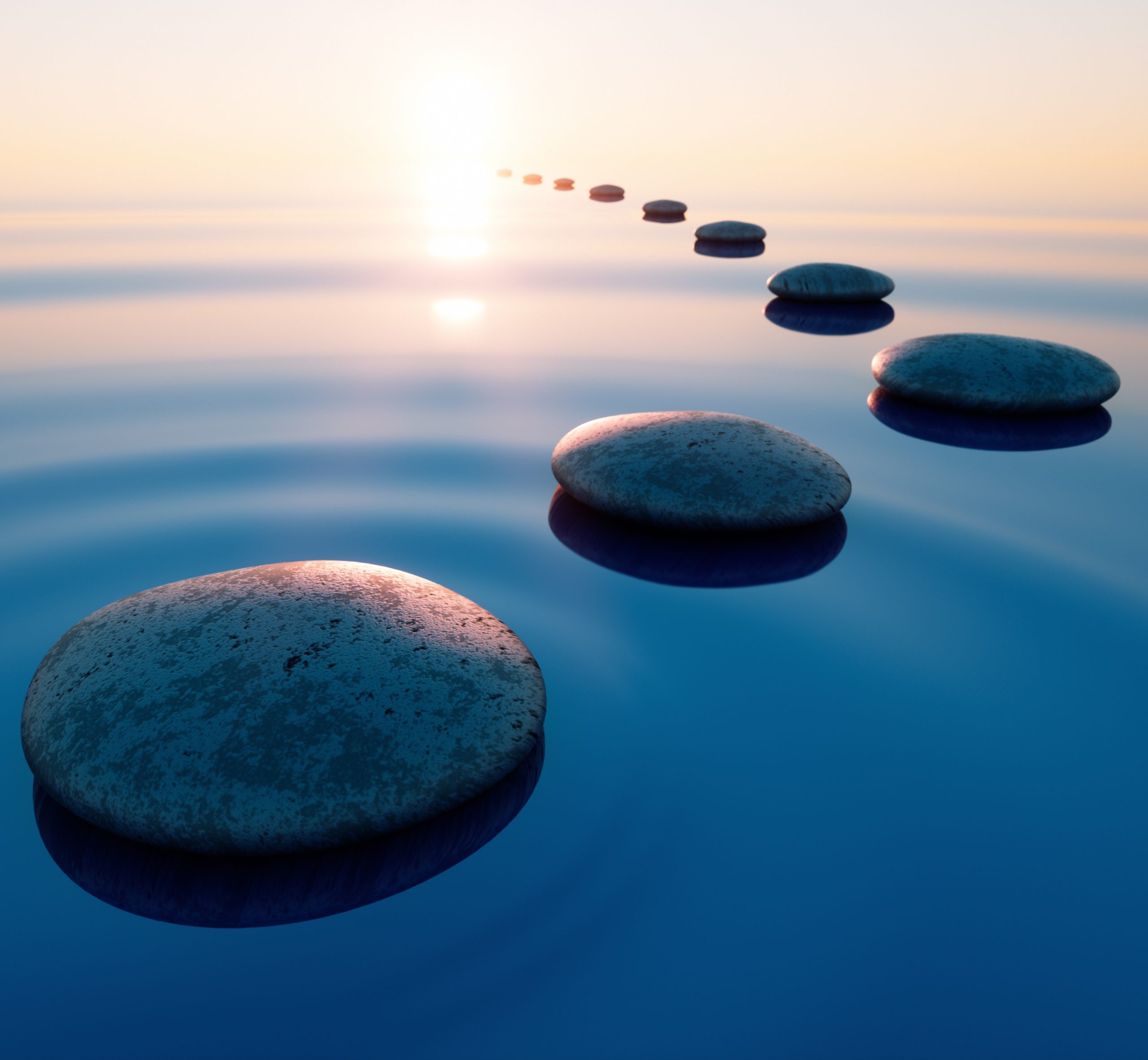 Image of stones in a lake receding into the distance.